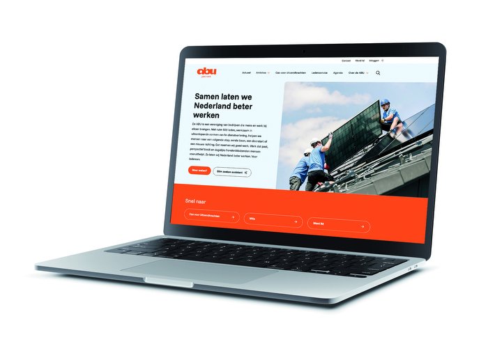 Laptopscherm toont een website met een oranje menubalk en een foto van dakwerkers die zonnepanelen installeren